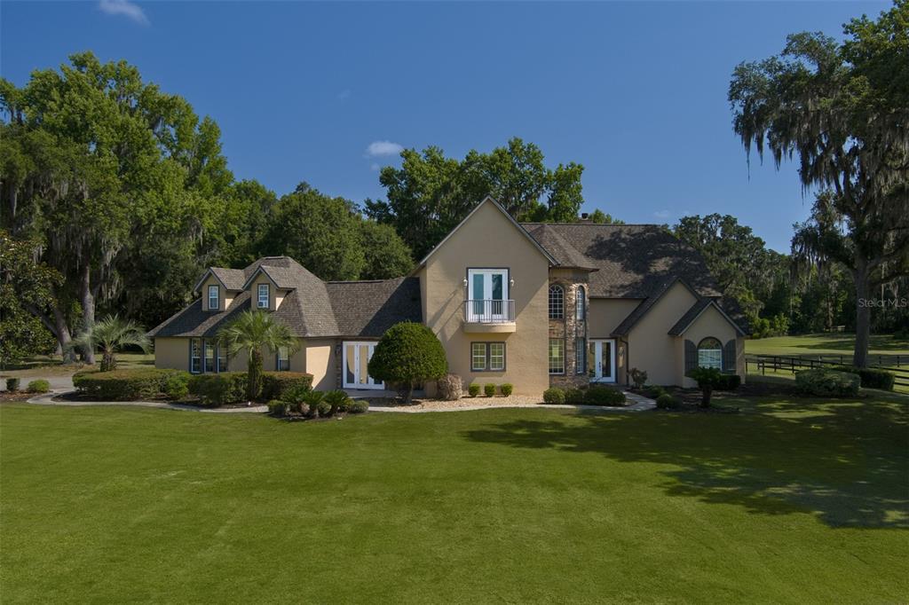 a front view of house with yard and green space