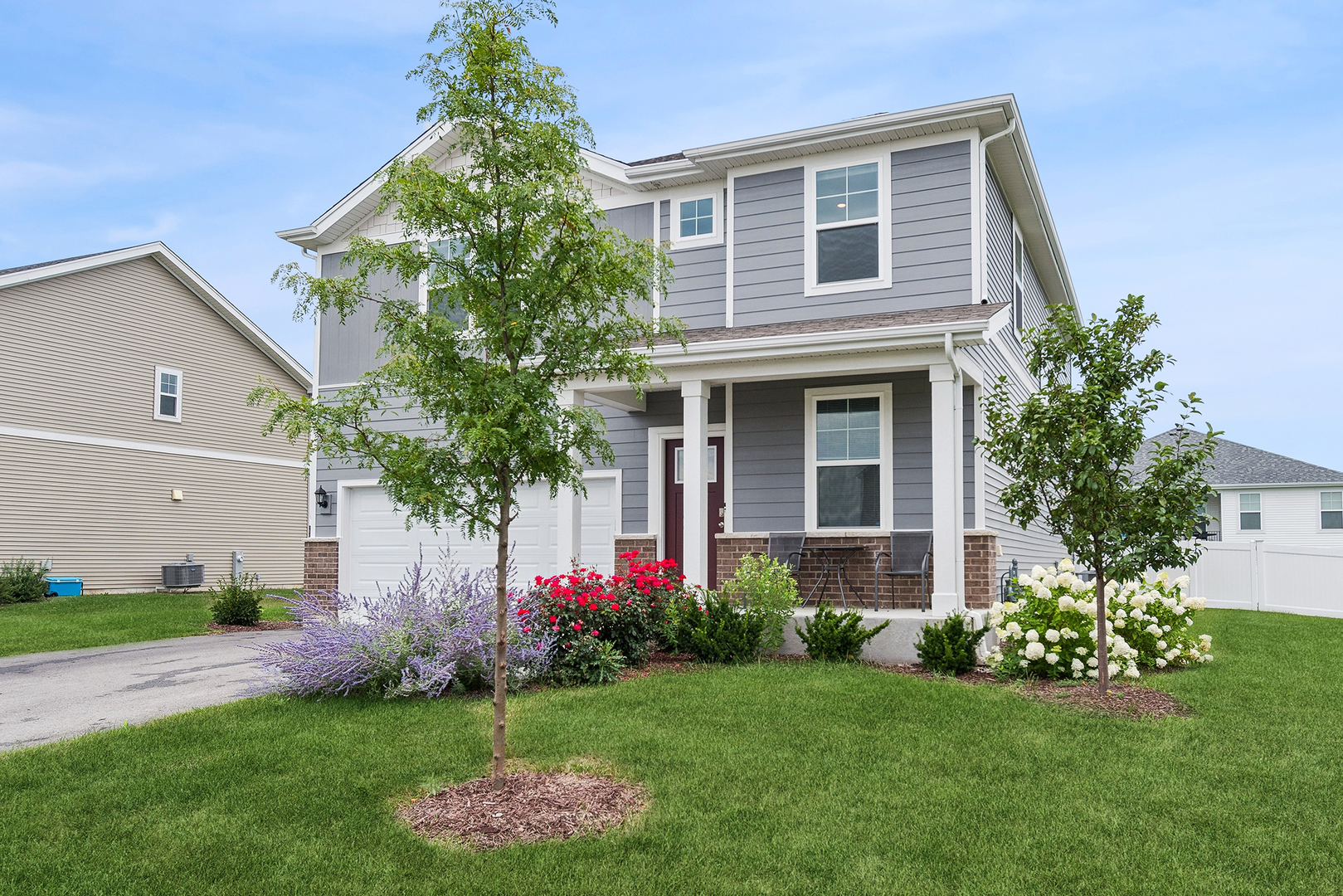 a front view of a house with a garden and plants