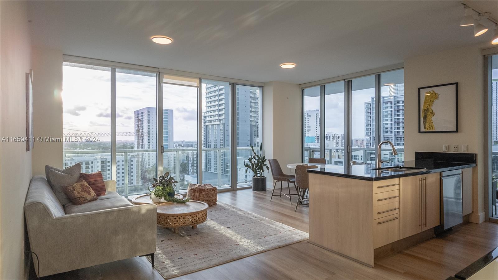 a living room with furniture and large windows