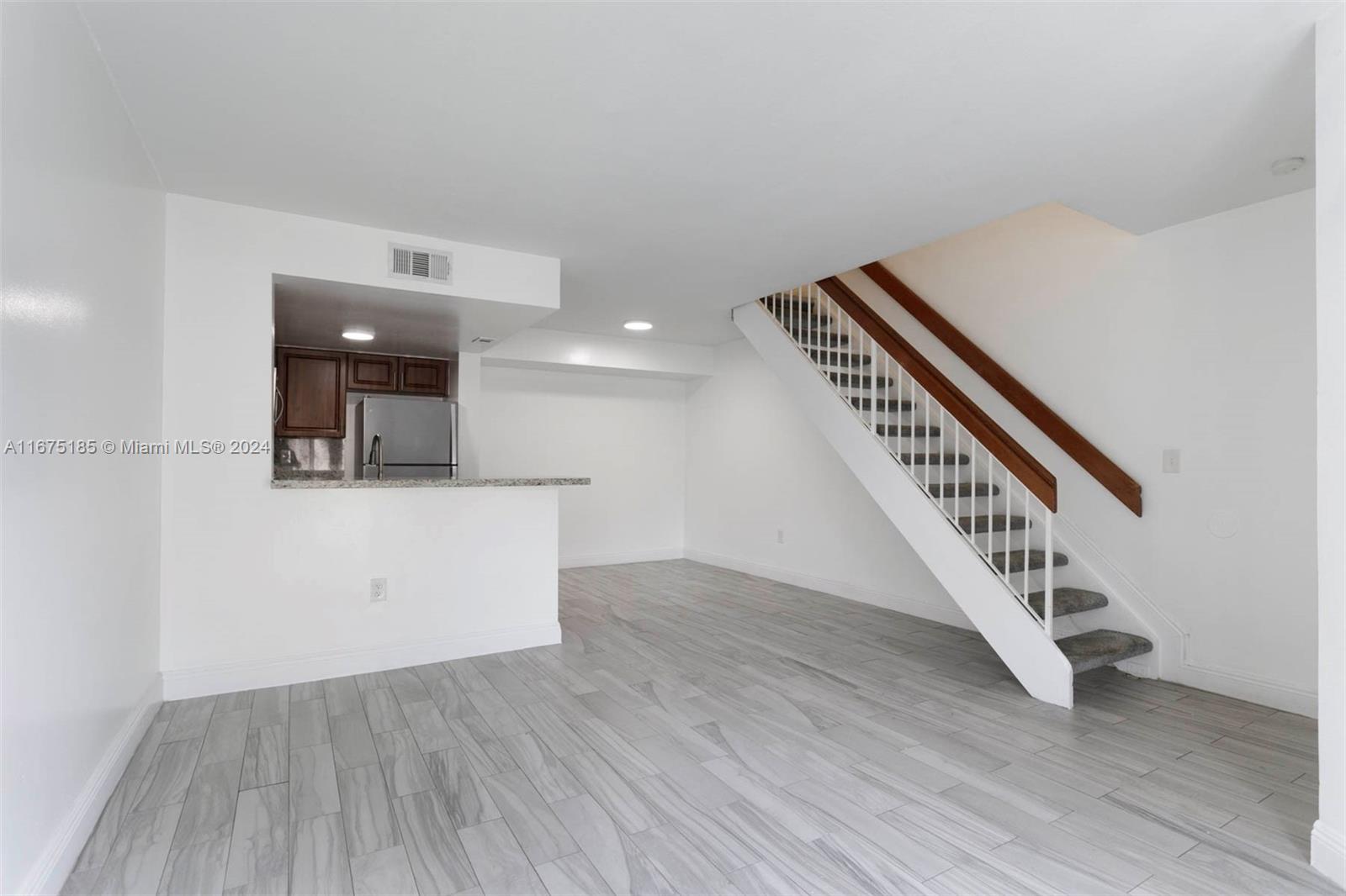 a view of an entryway with wooden floor