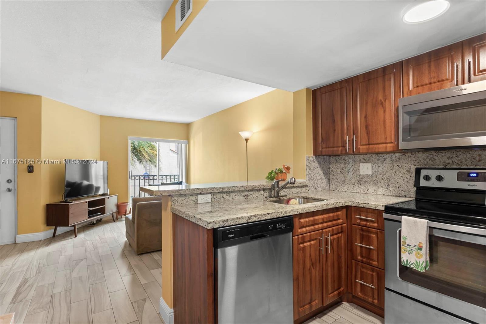 a kitchen with stainless steel appliances granite countertop a sink stove and oven