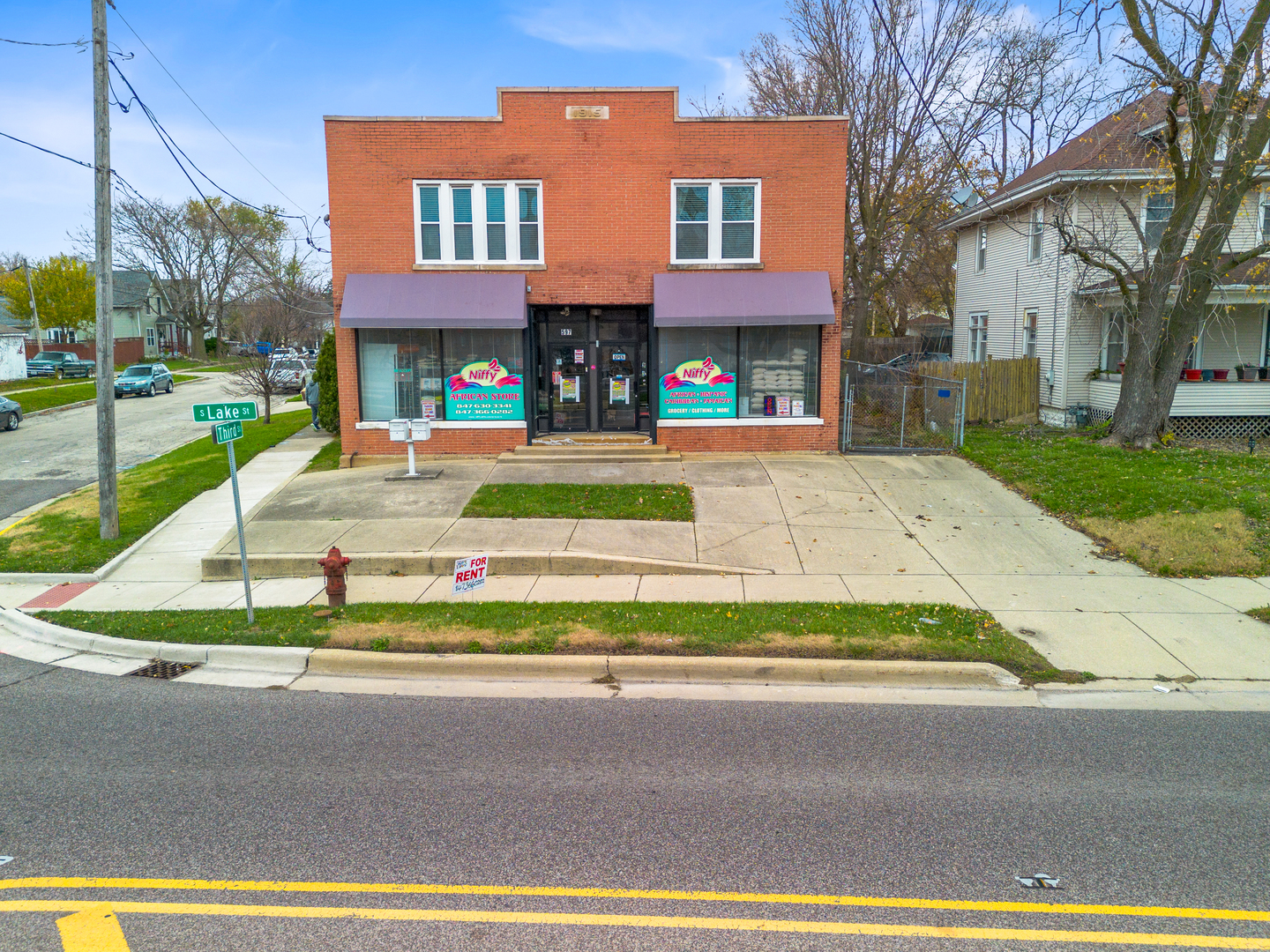 a view of a brick building next to a yard