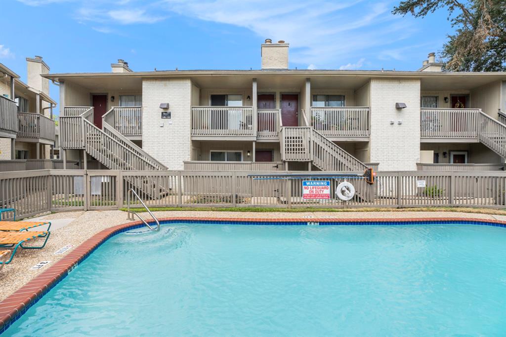 a view of a house with pool and sitting area