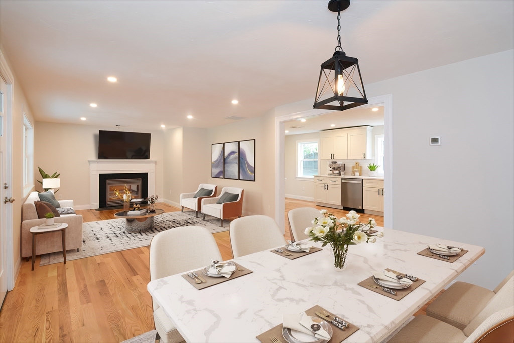 a living room with fireplace furniture and a wooden floor