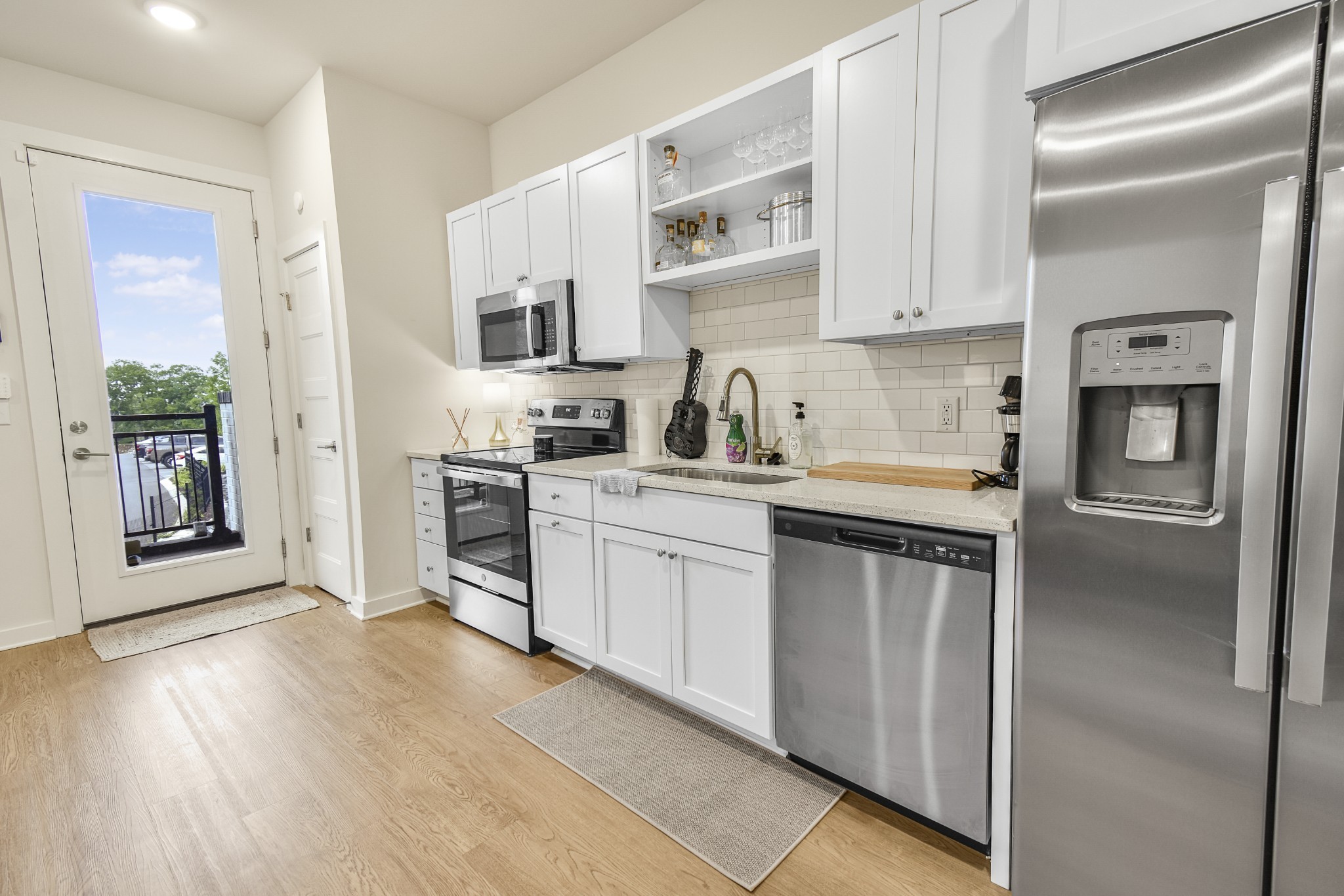 a kitchen with white cabinets and stainless steel appliances