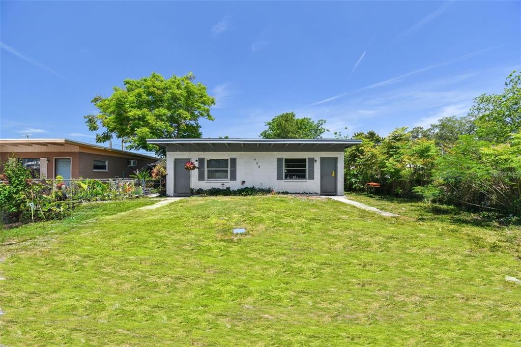 a front view of house with yard and trees