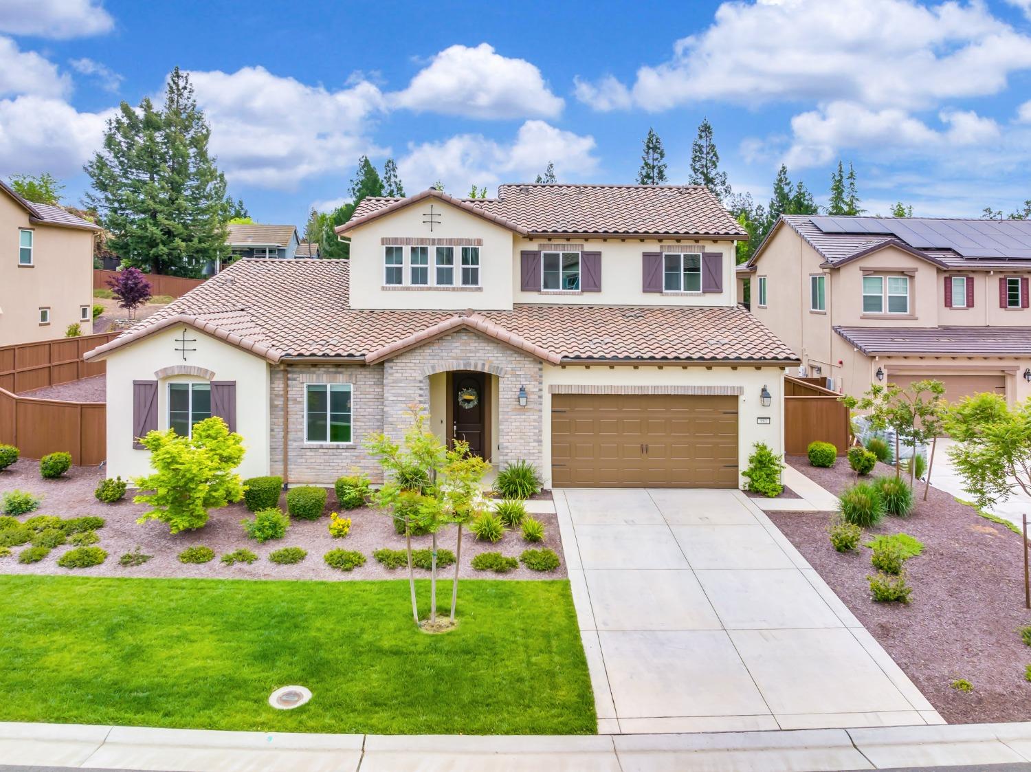 a front view of a house with garden