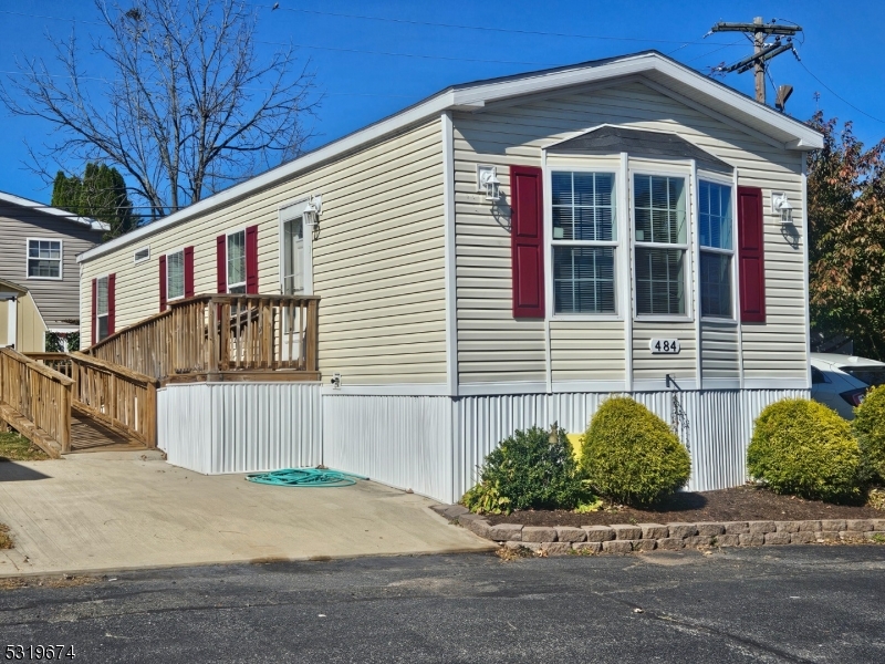 a front view of a house with garage and parking