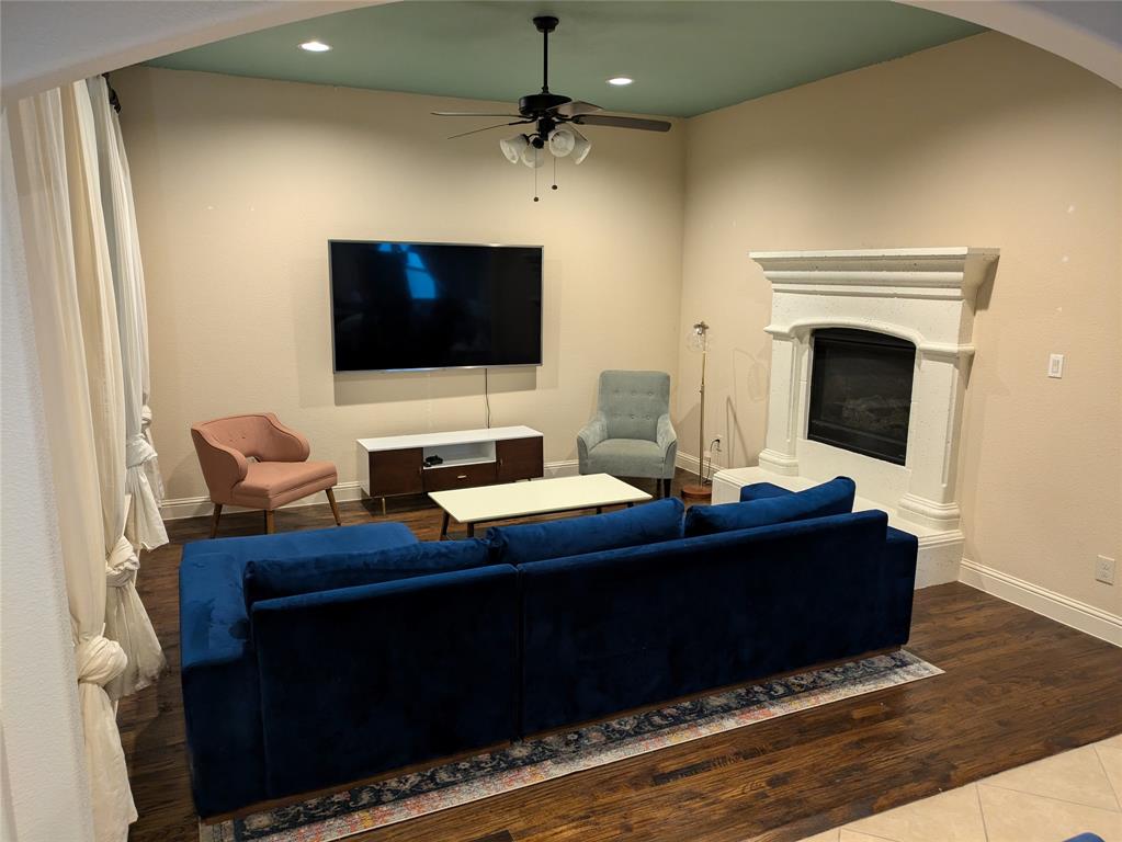 a living room with a flat screen tv and a fireplace