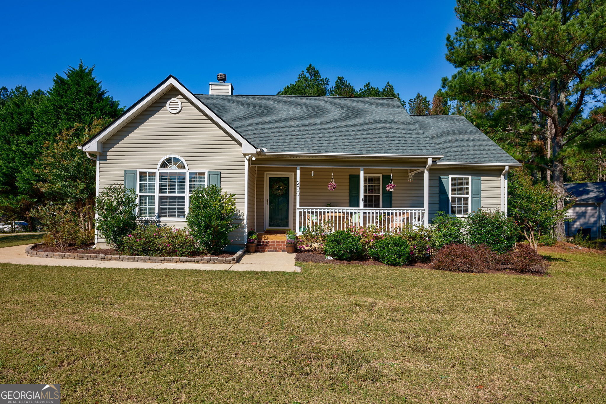 a front view of house with yard and green space