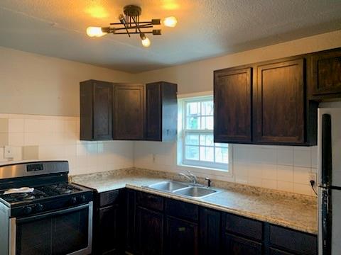 a kitchen with a sink appliances and cabinets