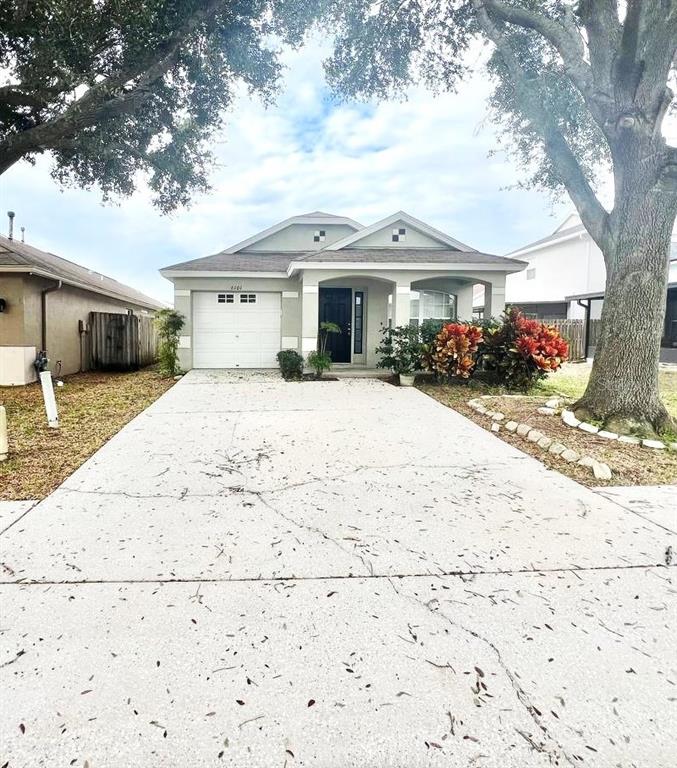 a front view of a house with a yard covered in snow