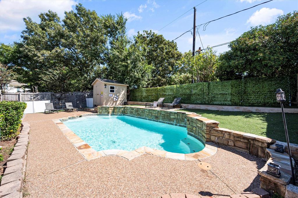 a view of a swimming pool with a yard