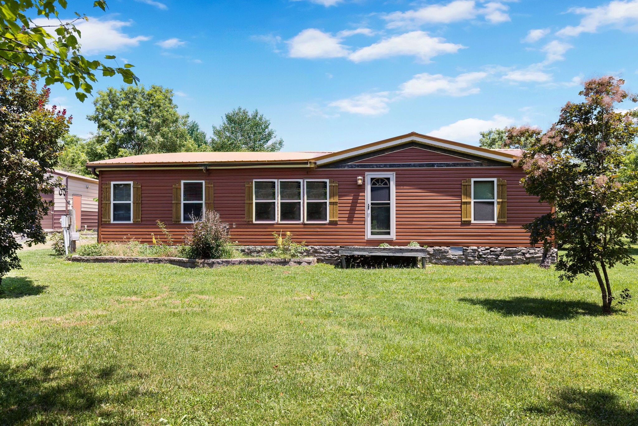 a front view of house with yard and green space