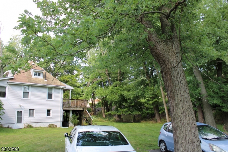 a view of a white house with a yard