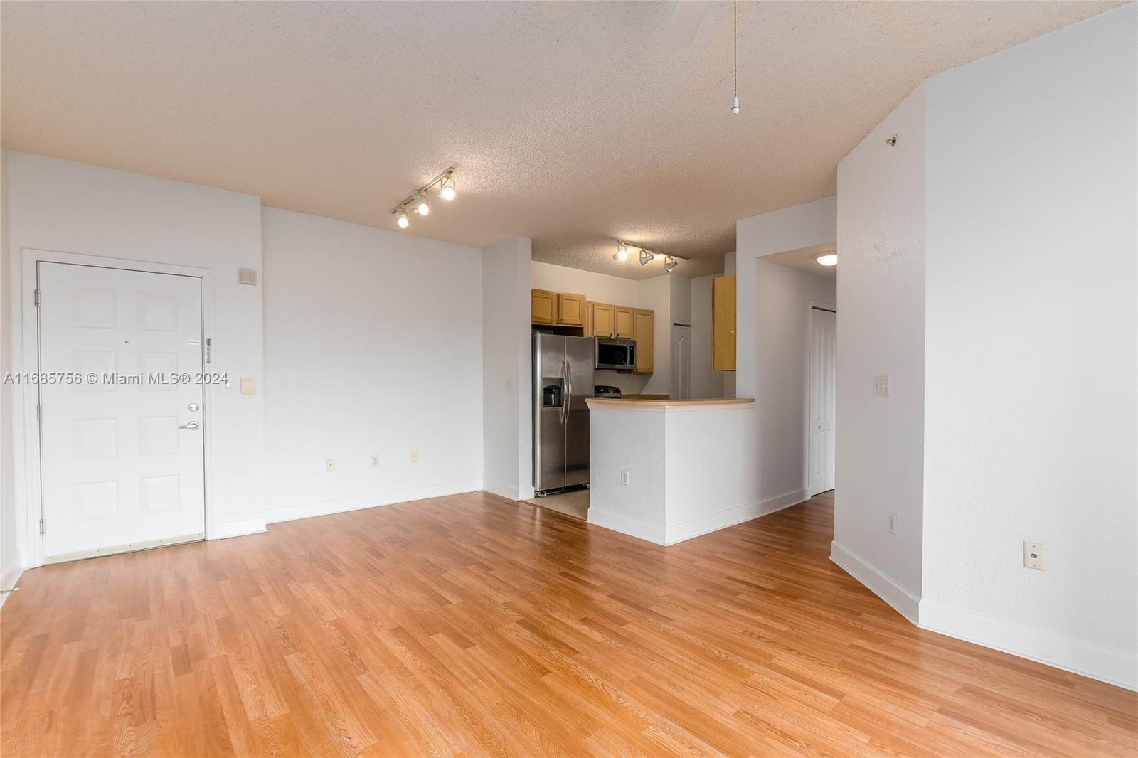 a view of a kitchen with wooden floor