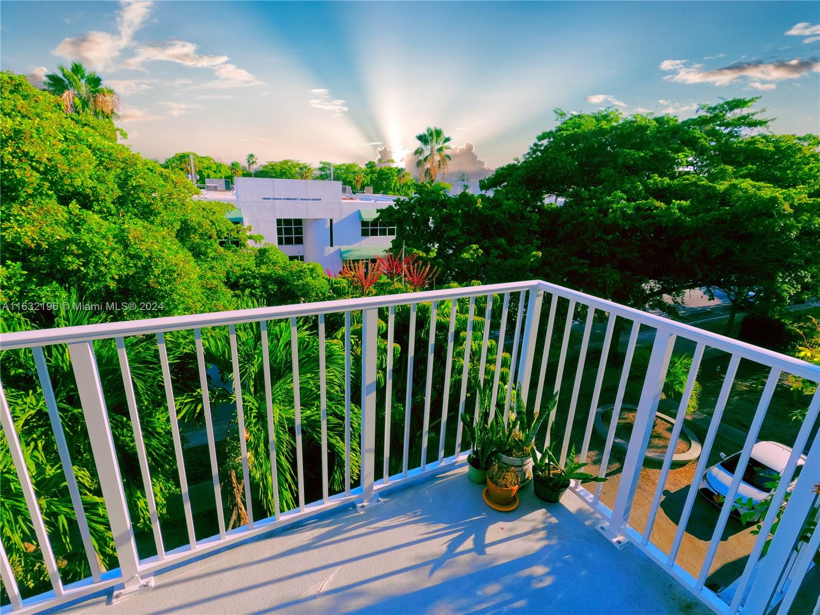 a balcony with view of potted plants in front of it