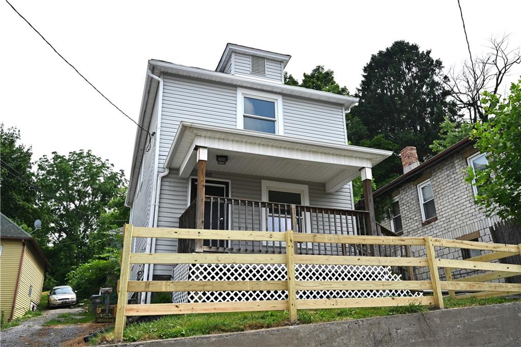 a front view of a house with a iron fence