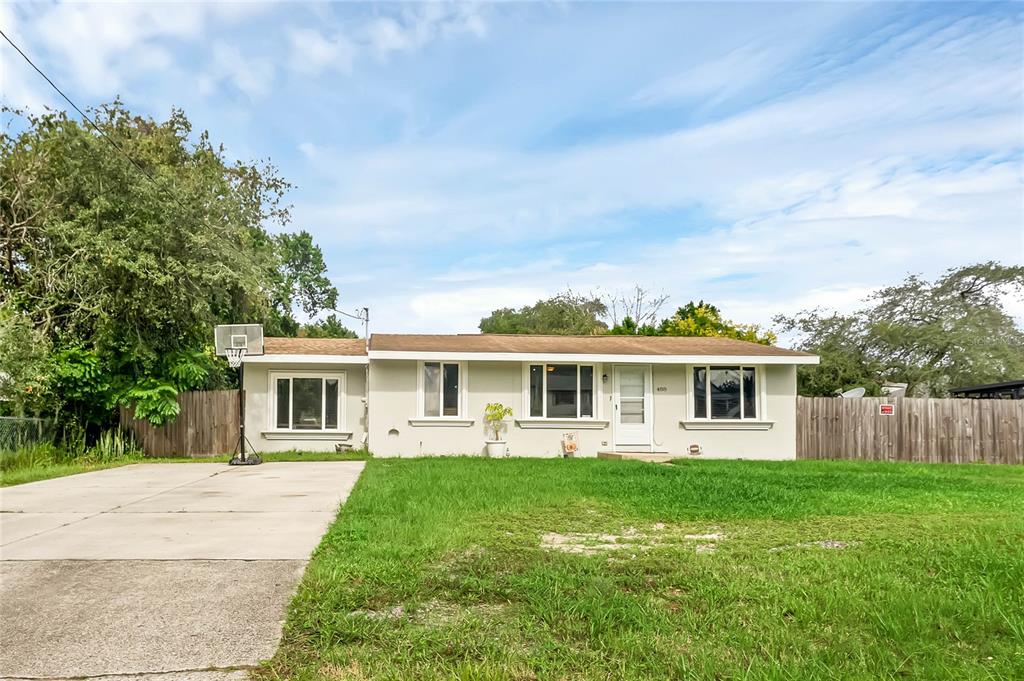 a front view of house with yard and green space