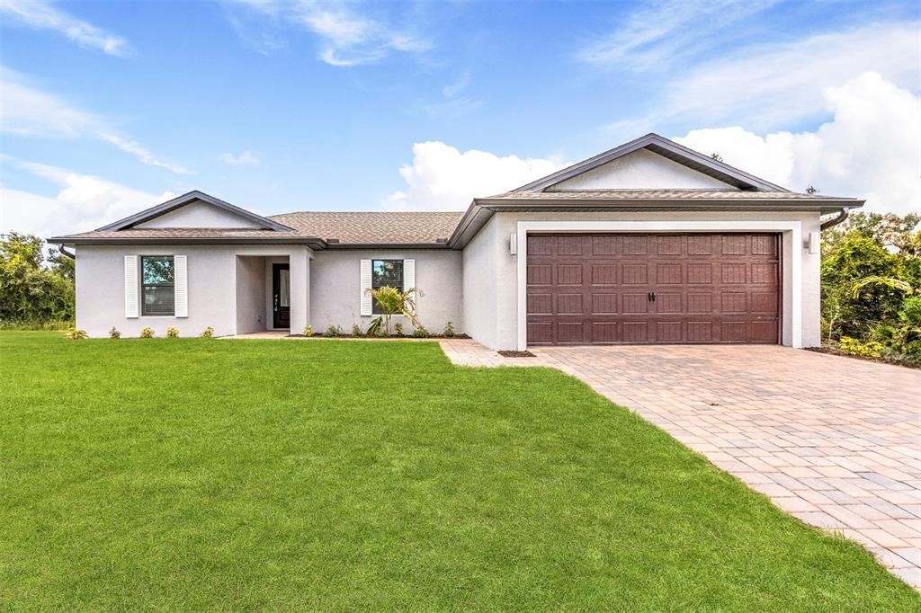 a front view of a house with a yard and garage