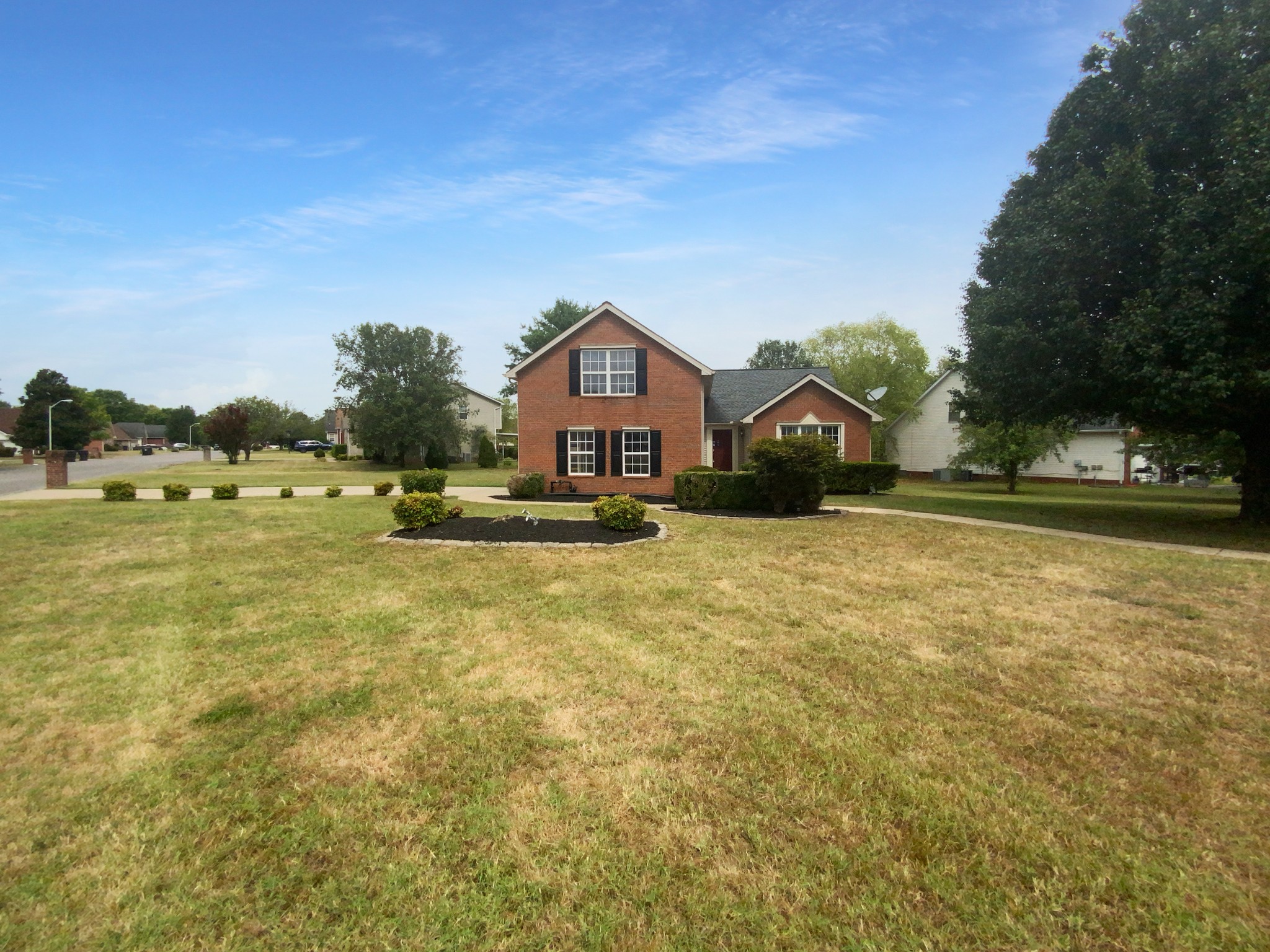 a front view of a house with a yard