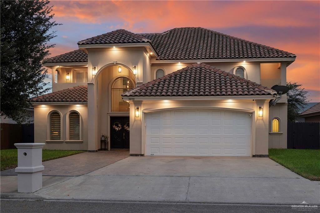 a front view of a house with a yard and garage