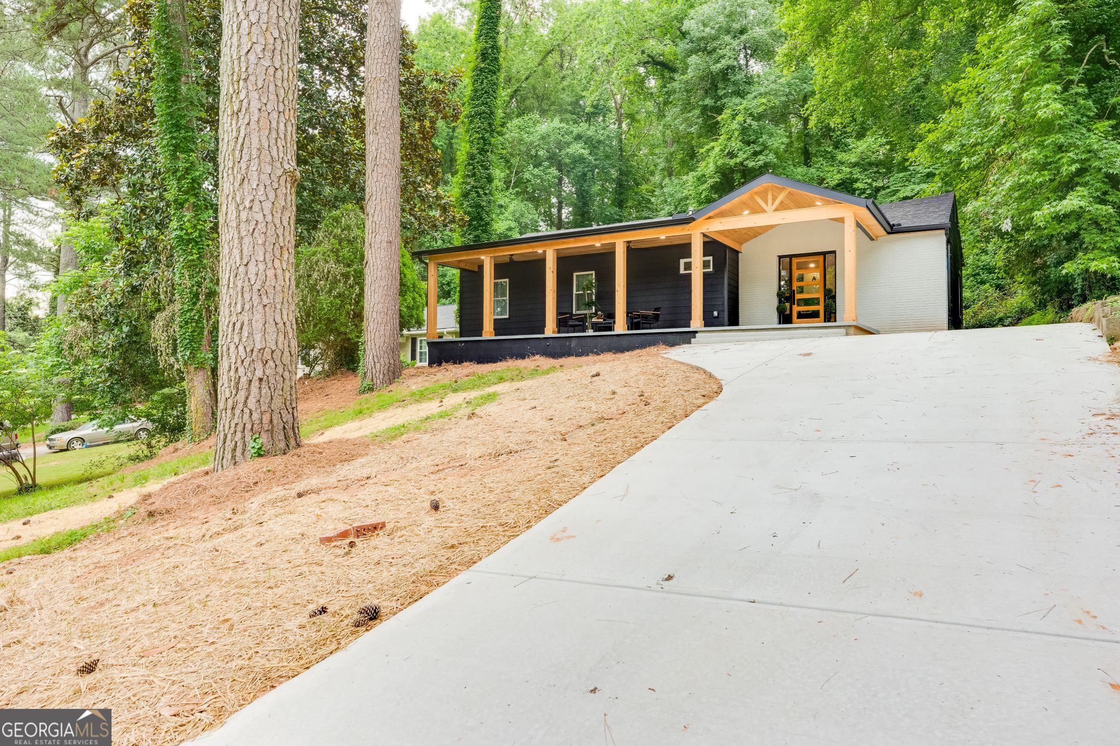 a front view of a house with a garden