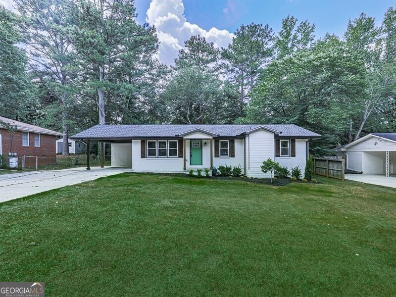 a front view of a house with a garden