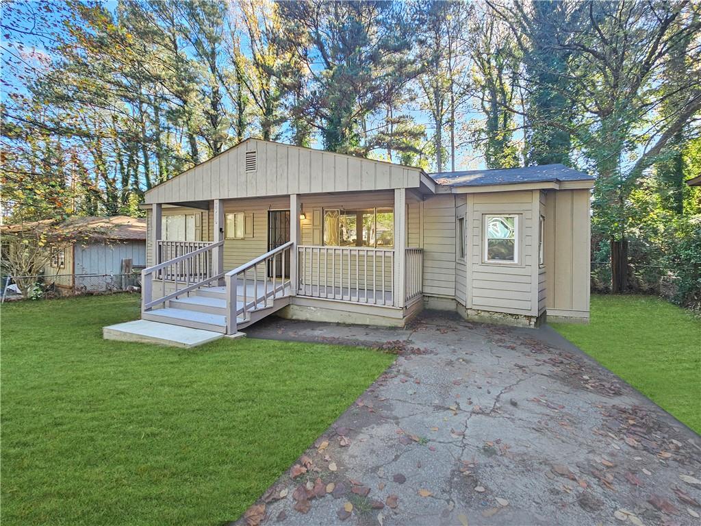 a view of a house with a yard and deck