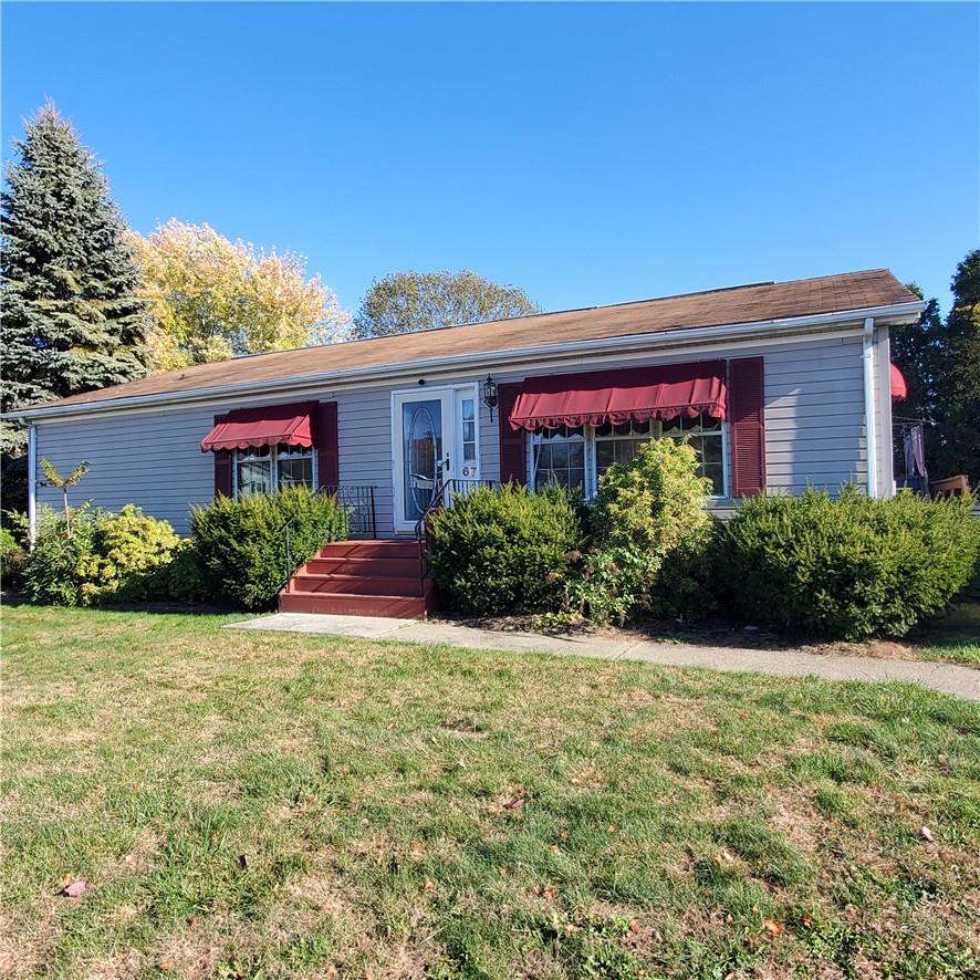 Single story home featuring a front lawn