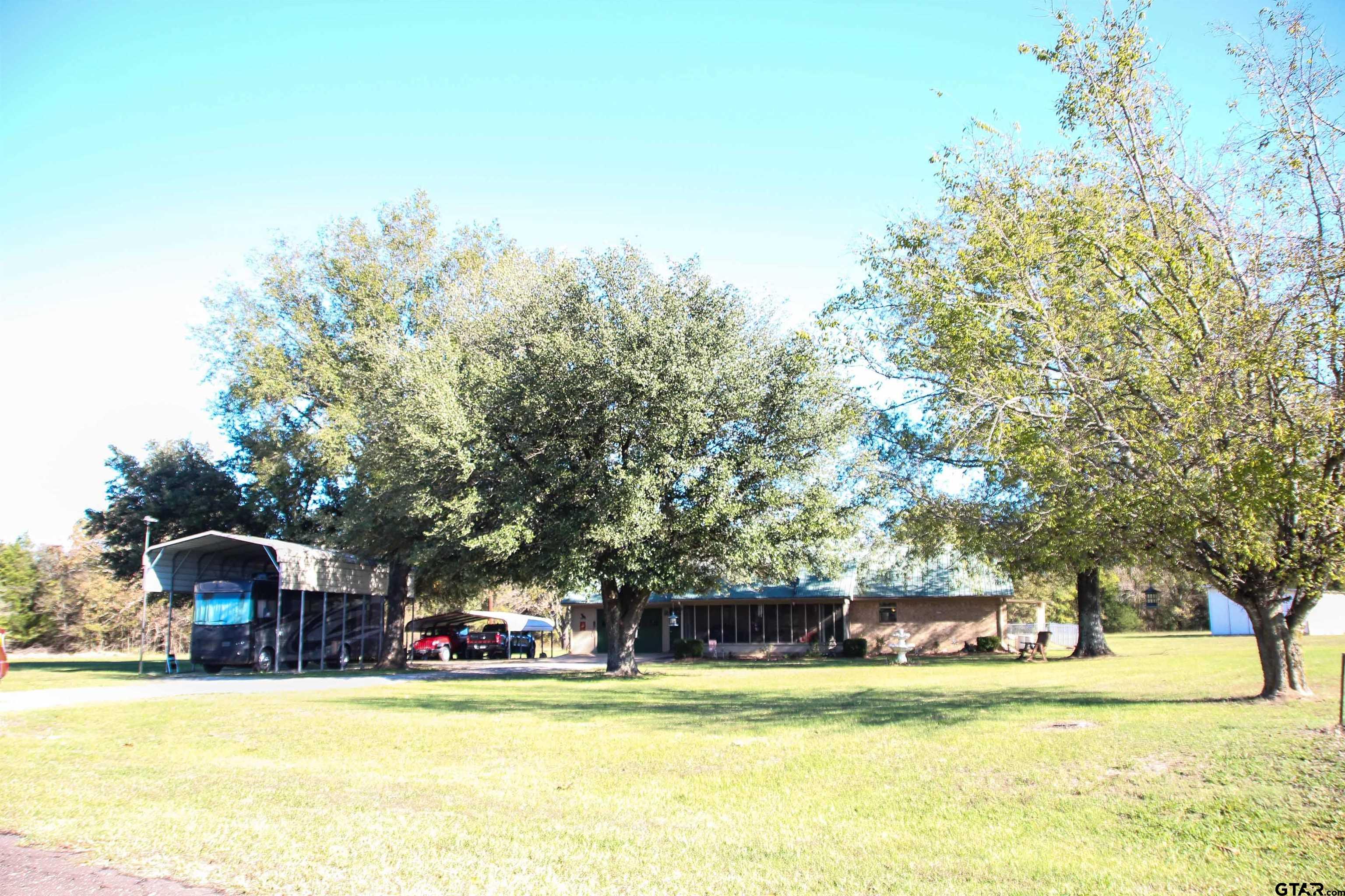 a view of a swimming pool and trees in the background