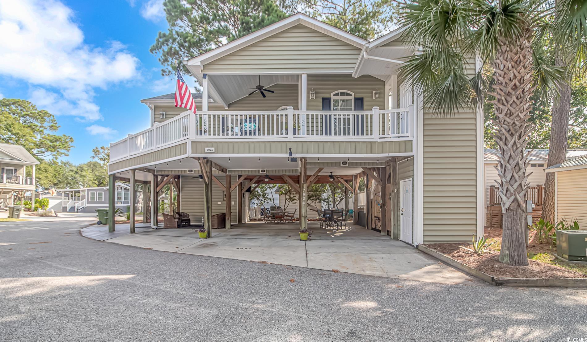 View of front of home with a carport, central AC,