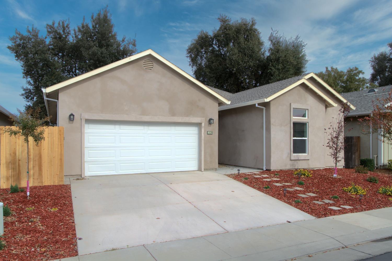 a view of a house with a yard and garage