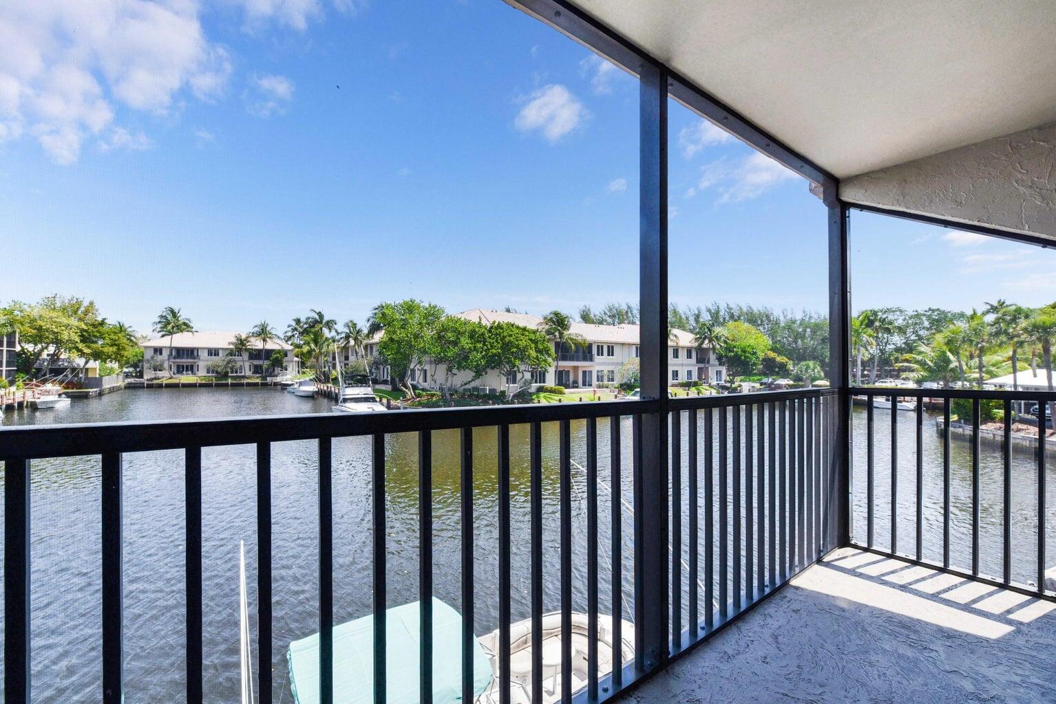 a view of a balcony with yard