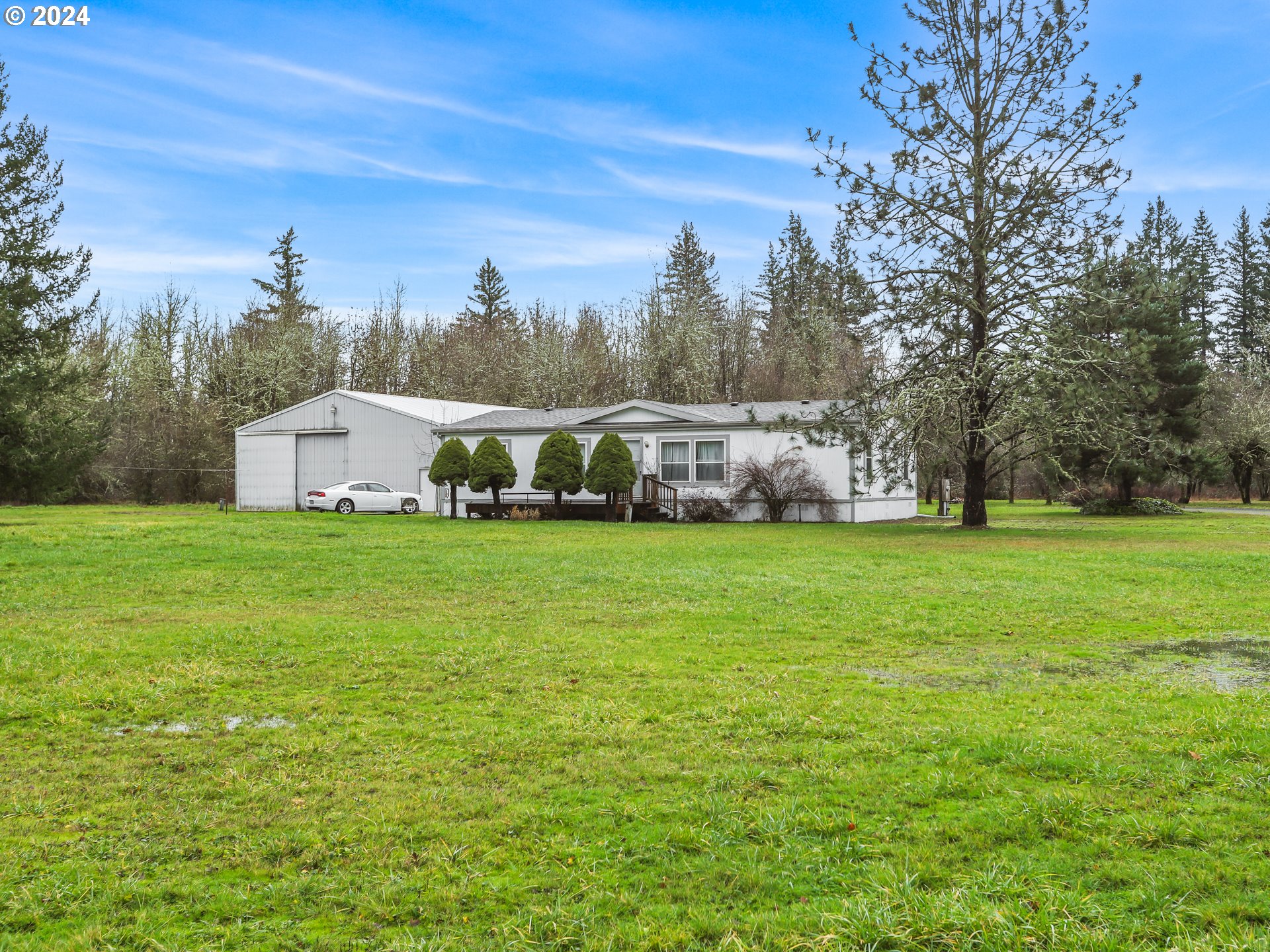 a view of house with garden space and trees