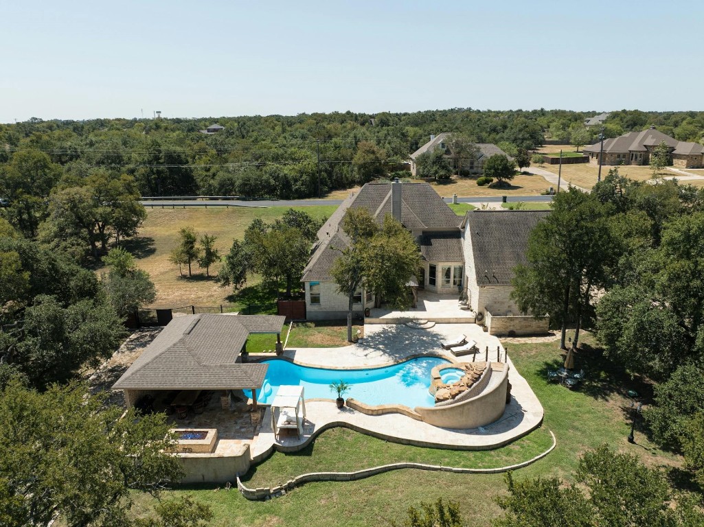 an aerial view of a house with yard swimming pool and outdoor seating