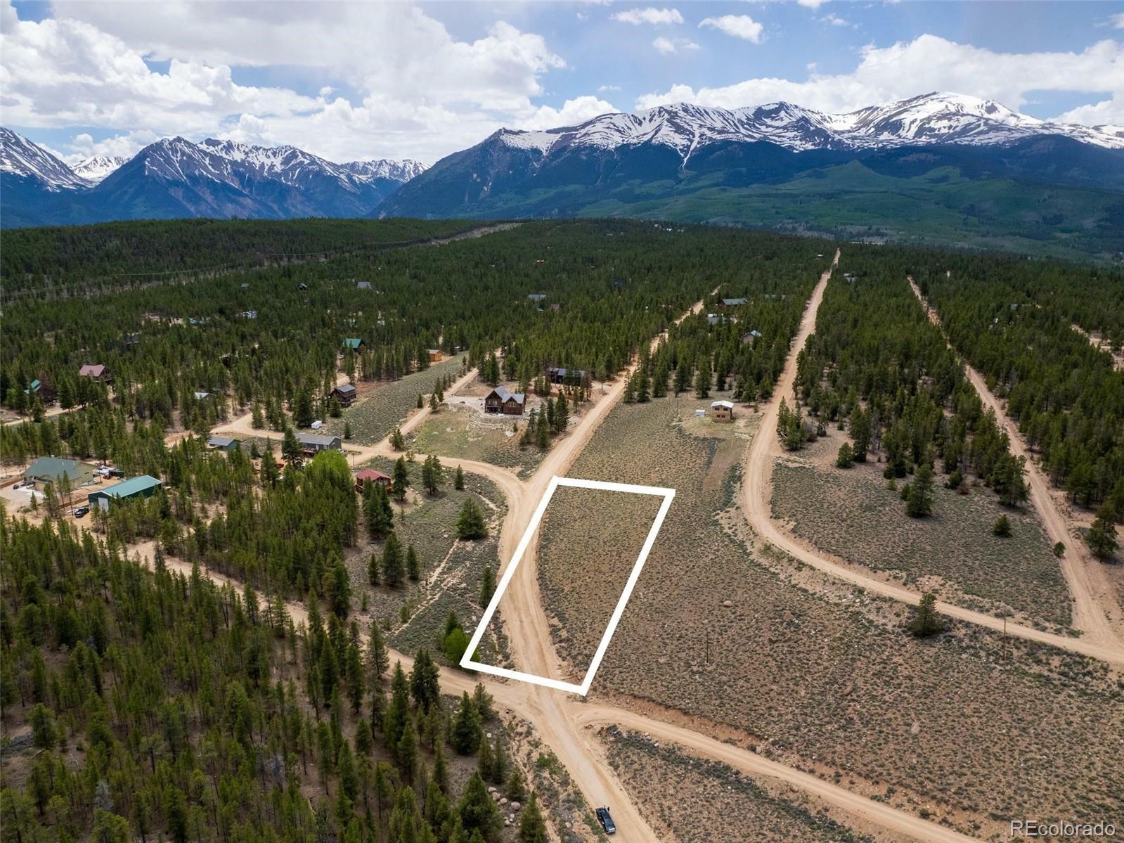 an aerial view of residential houses with outdoor space and seating