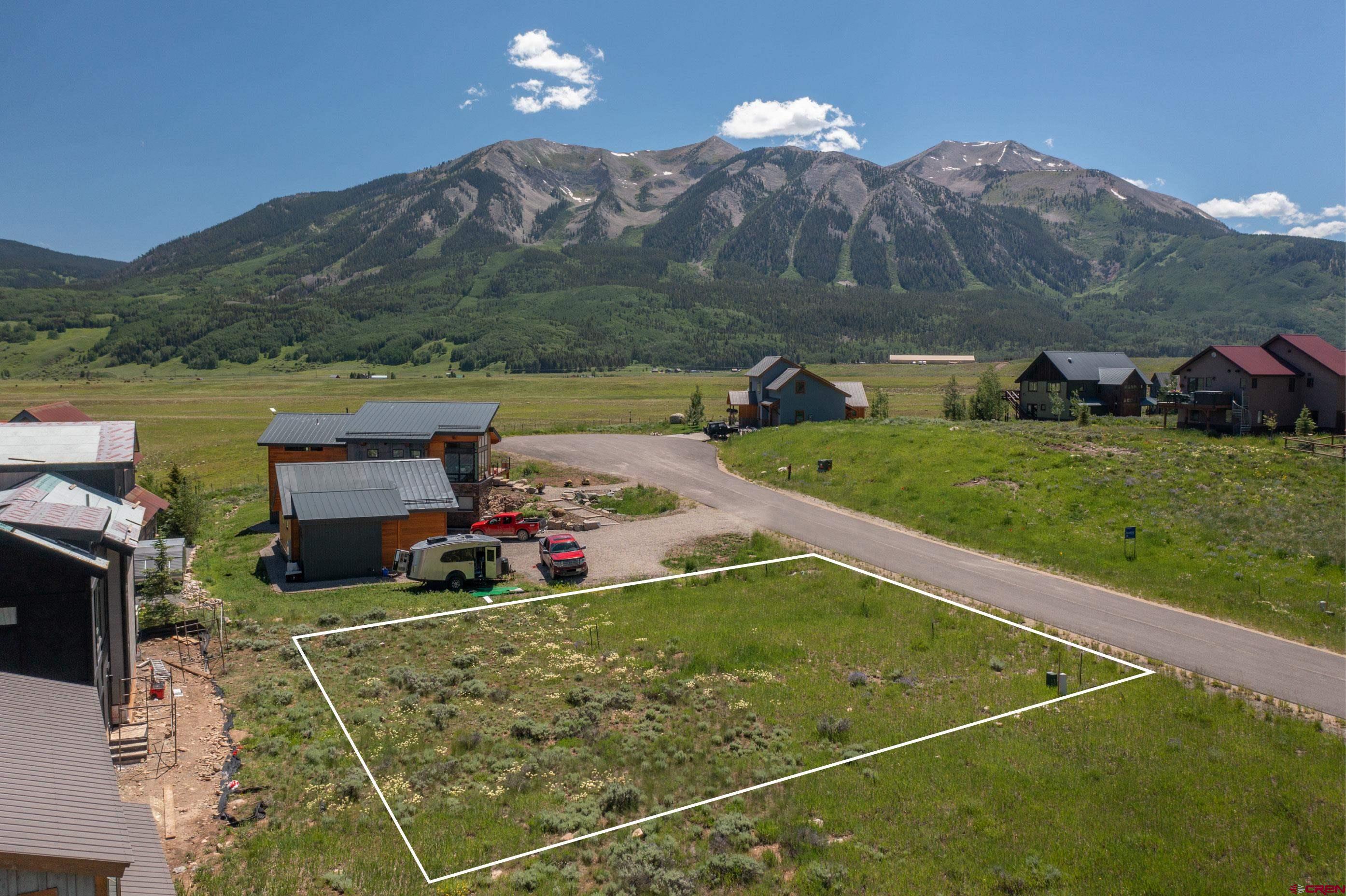 a view of a swimming pool with a yard and mountain view