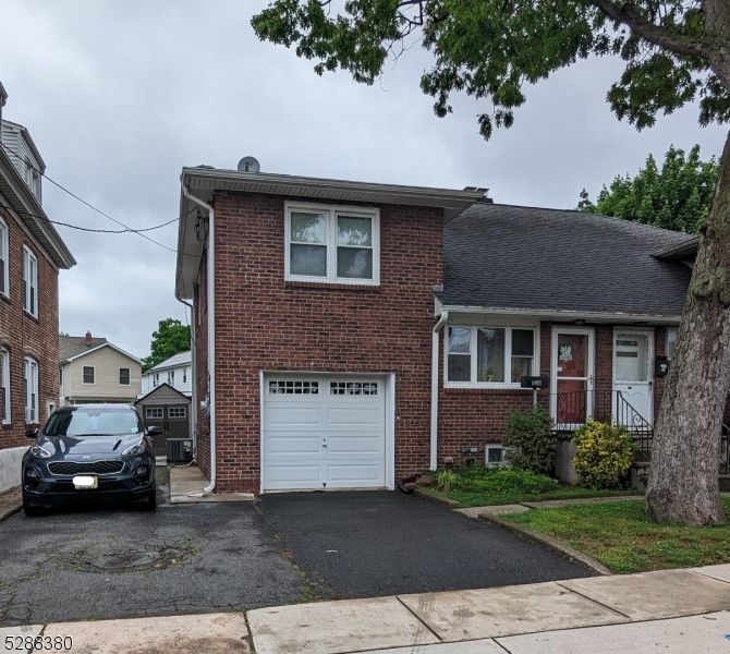 a car parked in front of a brick house