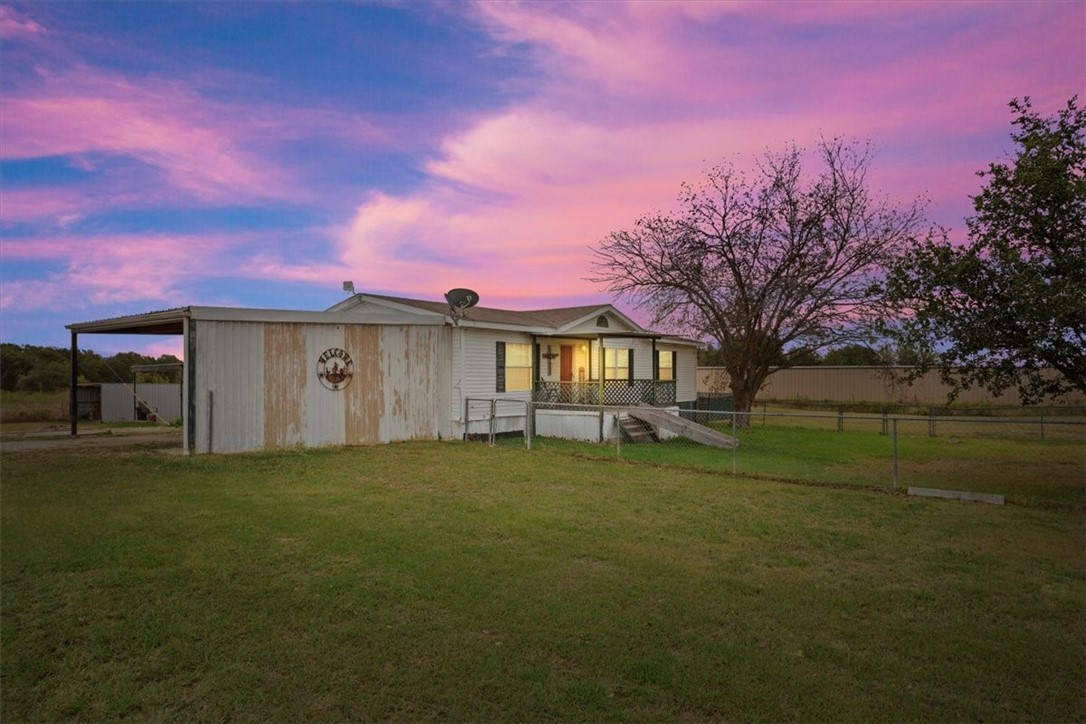 a view of a house with a yard