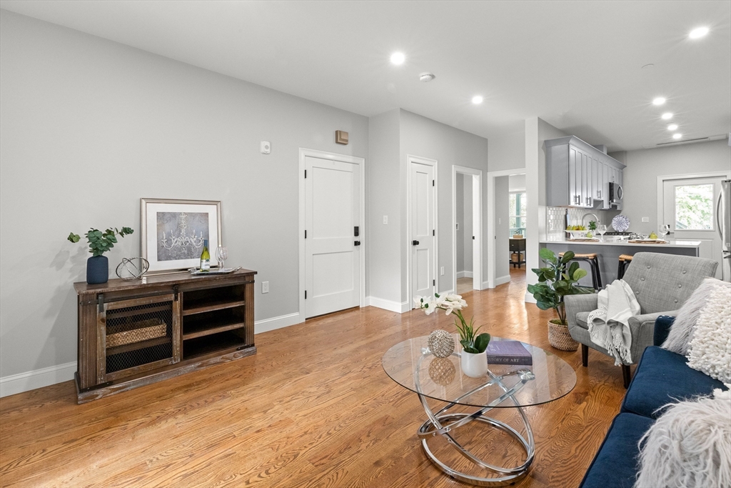 a living room with furniture and wooden floor