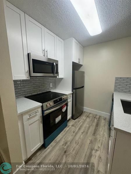 a kitchen with a stove microwave and refrigerator