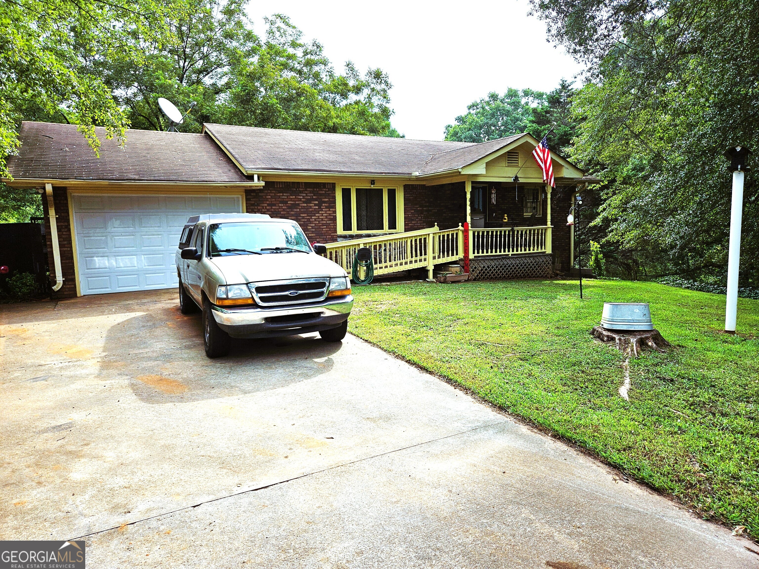 a front view of a house with a yard table and chairs