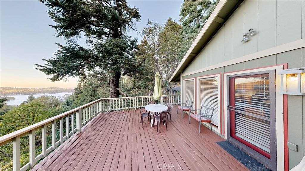 a view of balcony with chairs and wooden fence