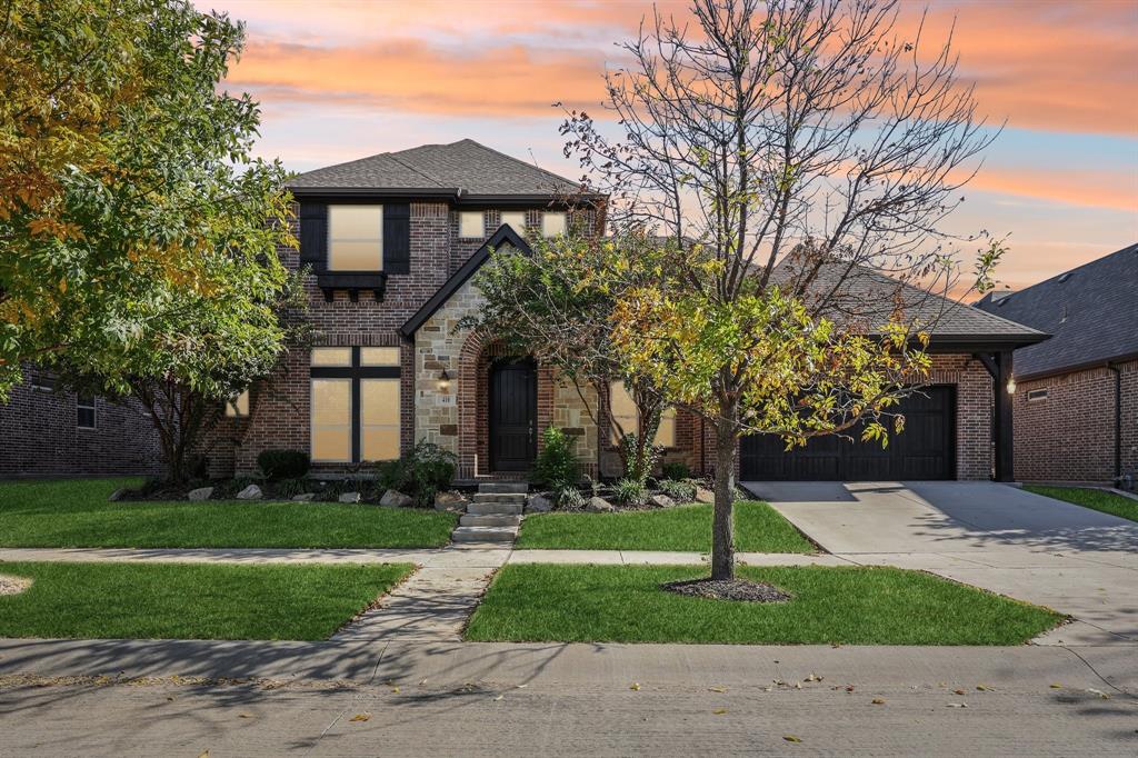 a front view of a house with a yard