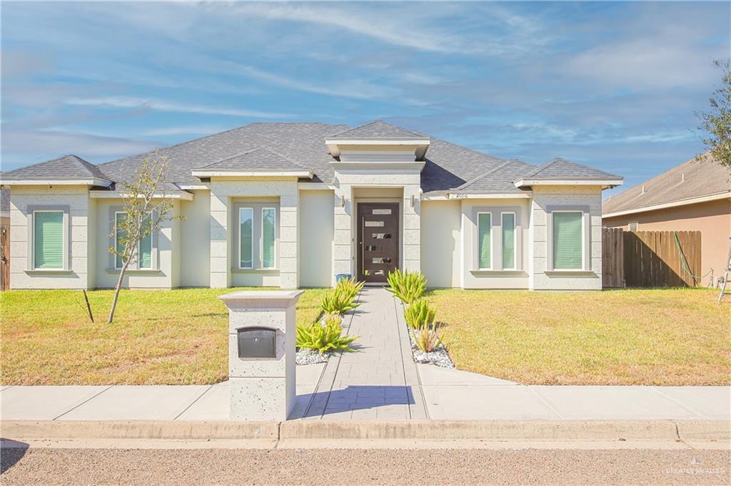 Prairie-style home featuring a front lawn