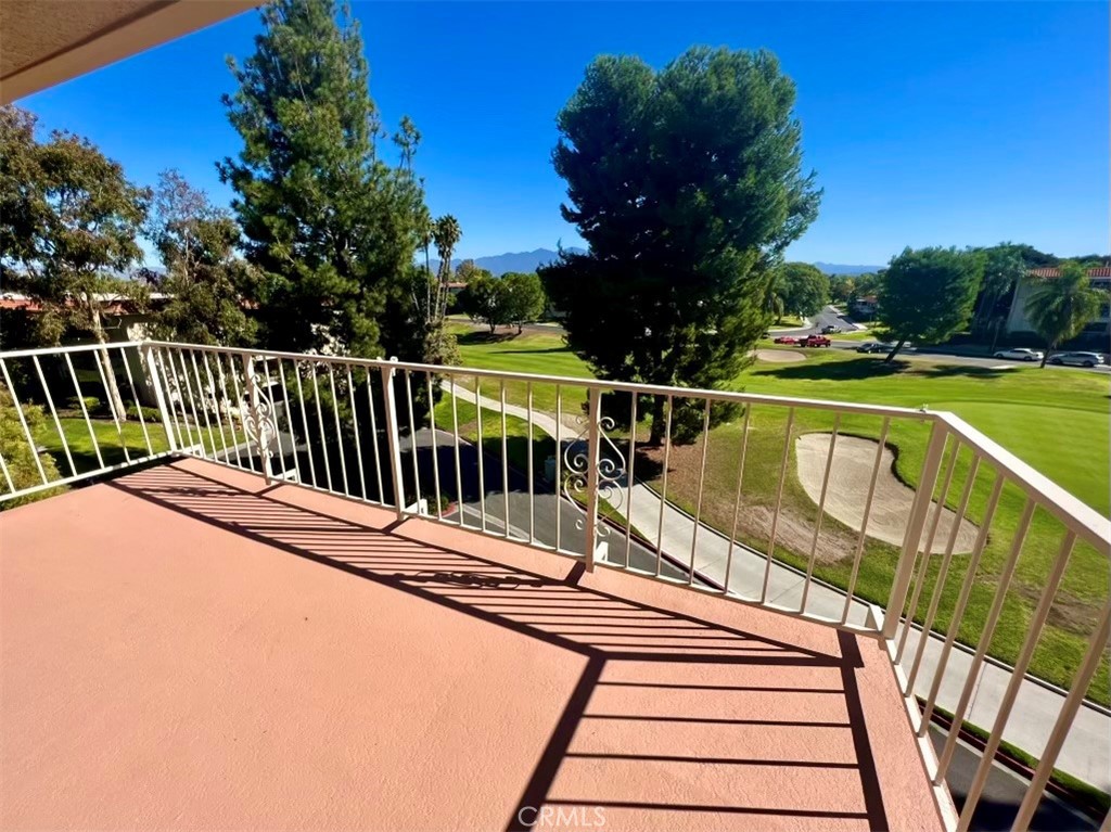 a view of balcony with wooden floor and outdoor seating