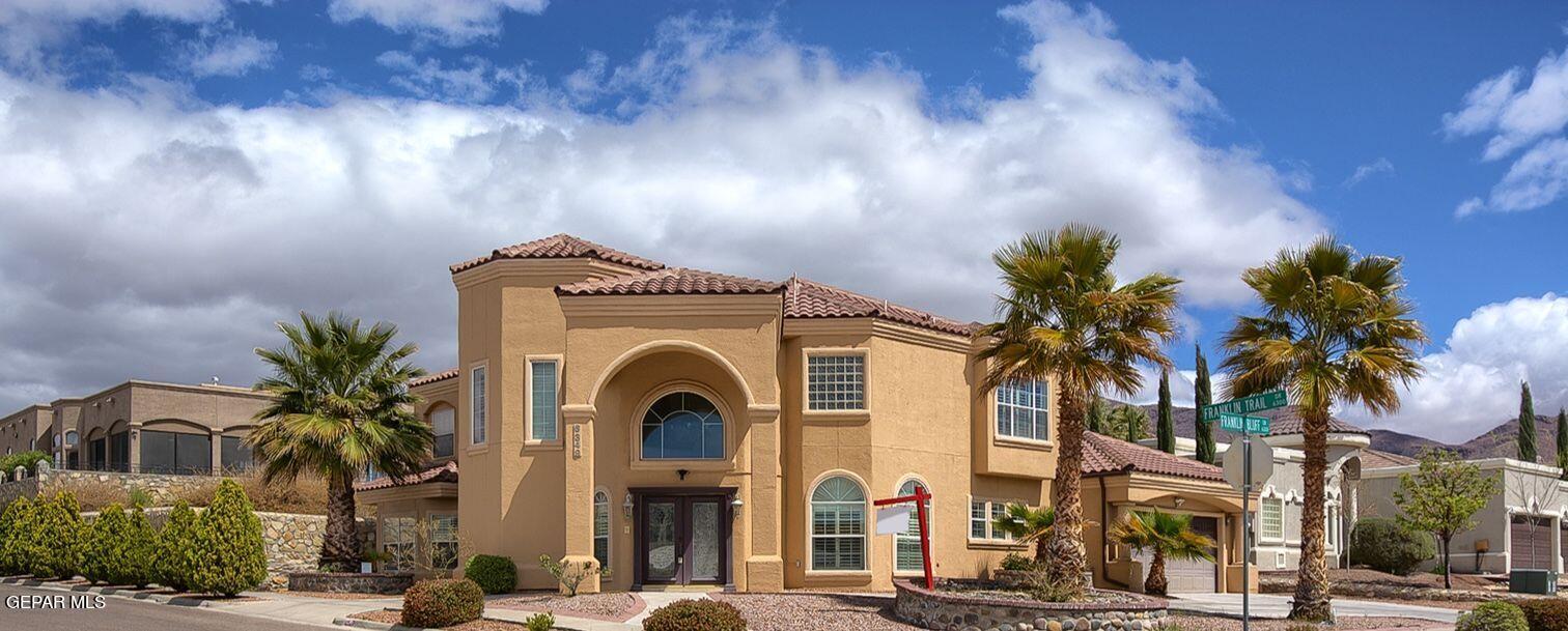 a front view of a house with tree s