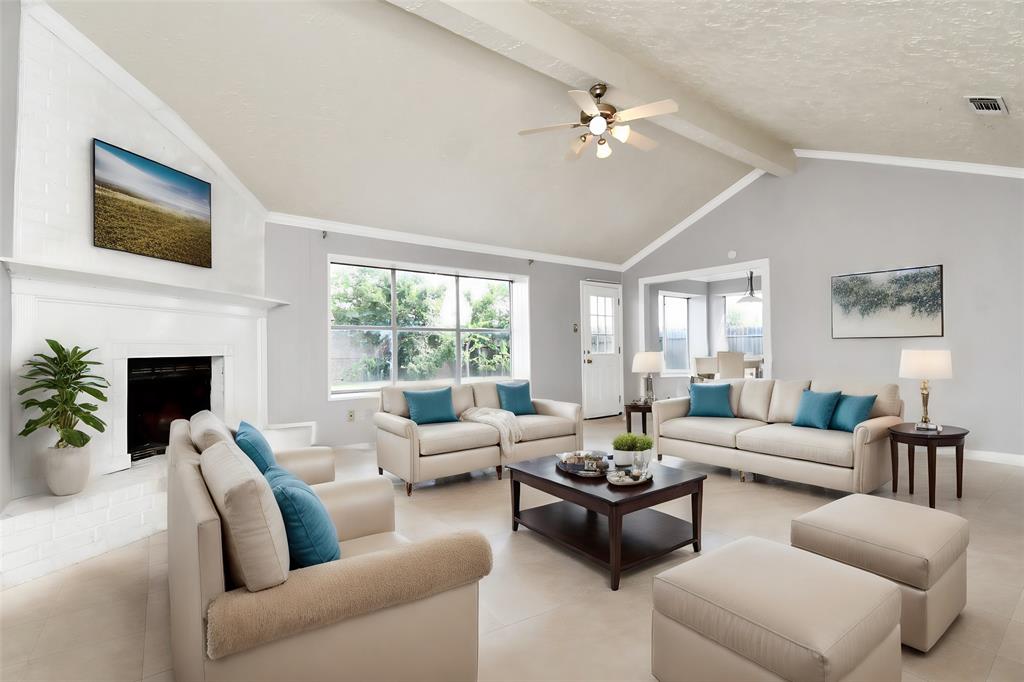 a living room with furniture and a fireplace