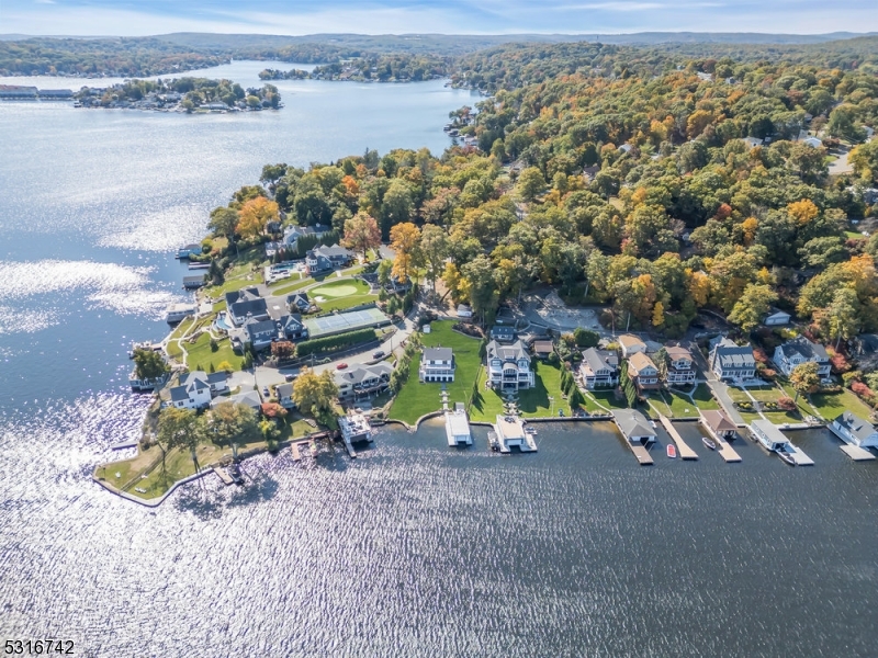 an aerial view of a house with a yard and lake view